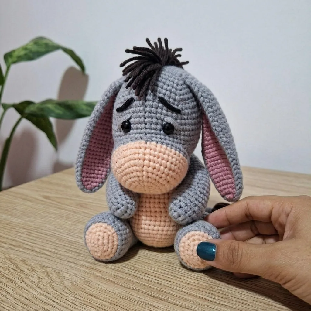 Finished donkey amigurumi held in hand